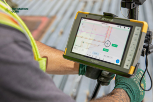 A construction worker uses a Topcon FC-6000 tablet to view building plans on-site
